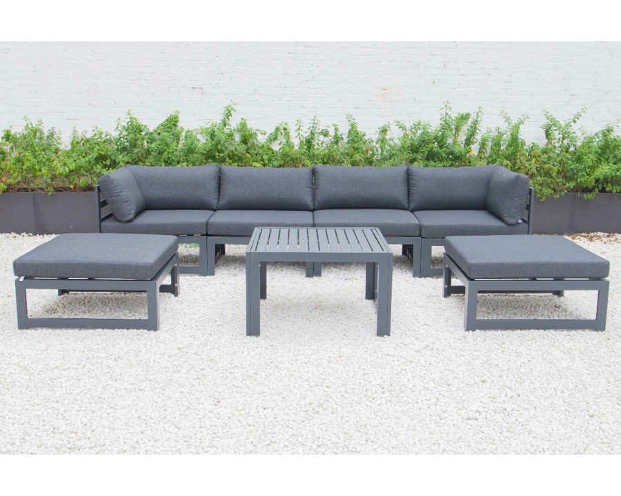 LeisureMod Chelsea 7-Piece Patio Ottoman Sectional and Coffee Table Set Black Aluminum with Cushions - Black