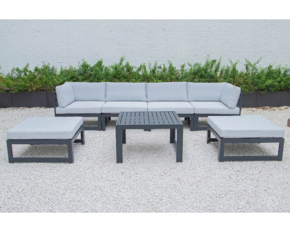 LeisureMod Chelsea 7-Piece Patio Ottoman Sectional and Coffee Table Set Black Aluminum with Cushions