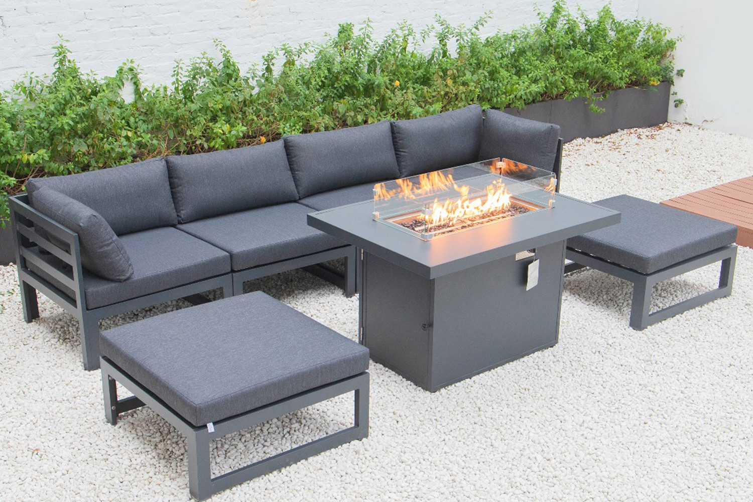 LeisureMod Chelsea 7-Piece Patio Ottoman Sectional and Fire Pit Table Black Aluminum with Cushions - Black