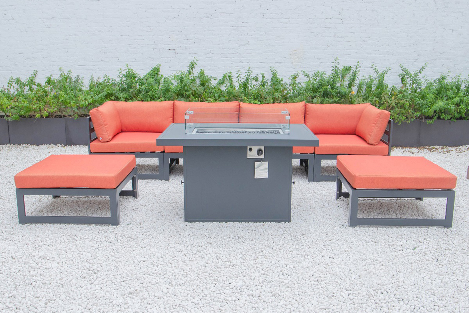 LeisureMod Chelsea 7-Piece Patio Ottoman Sectional and Fire Pit Table Black Aluminum with Cushions - Orange