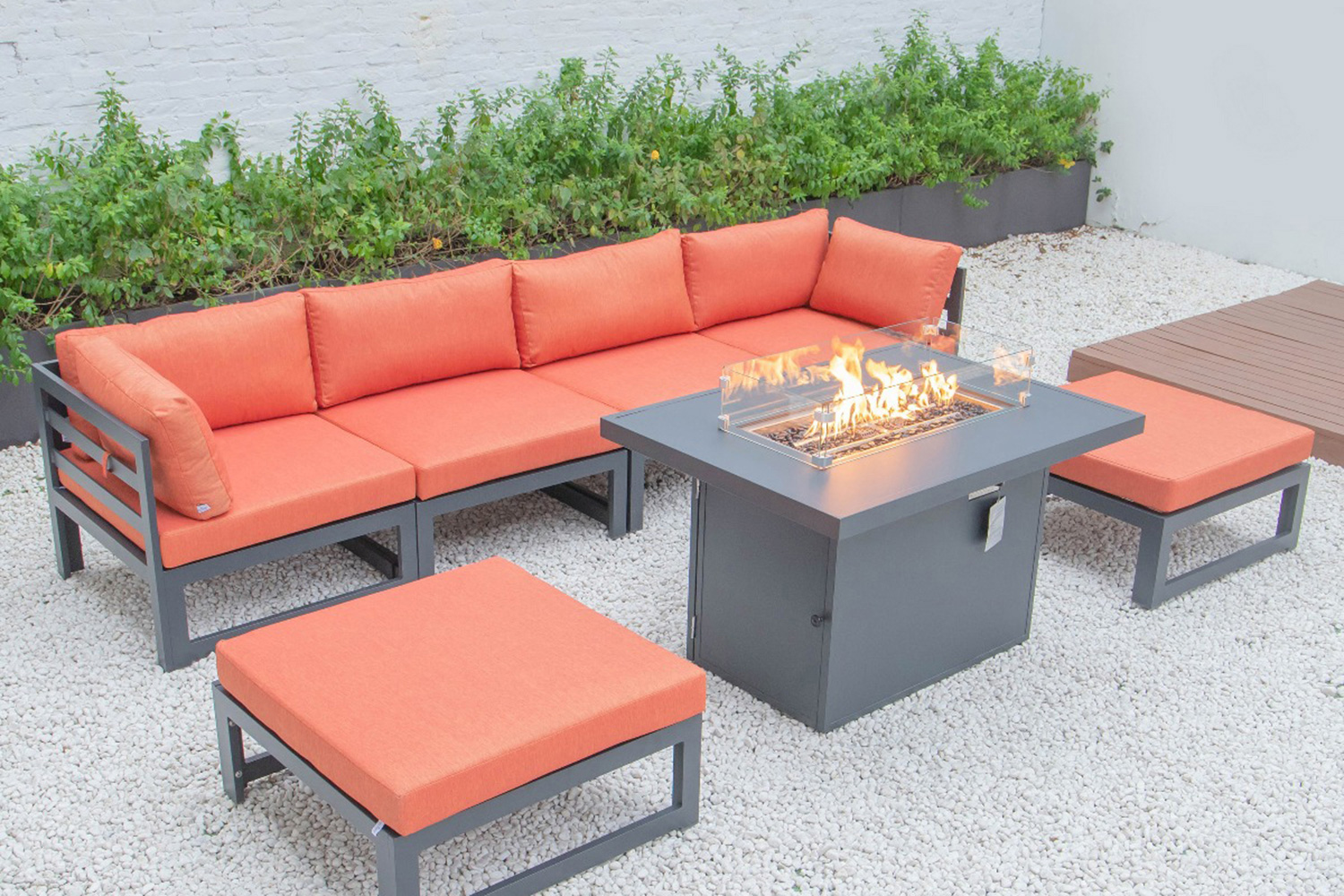 LeisureMod Chelsea 7-Piece Patio Ottoman Sectional and Fire Pit Table Black Aluminum with Cushions - Orange